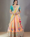 Mango And Peach Bandhej Lehenga Set With A Yellow Dupatta