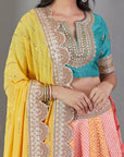 Mango And Peach Bandhej Lehenga Set With A Yellow Dupatta